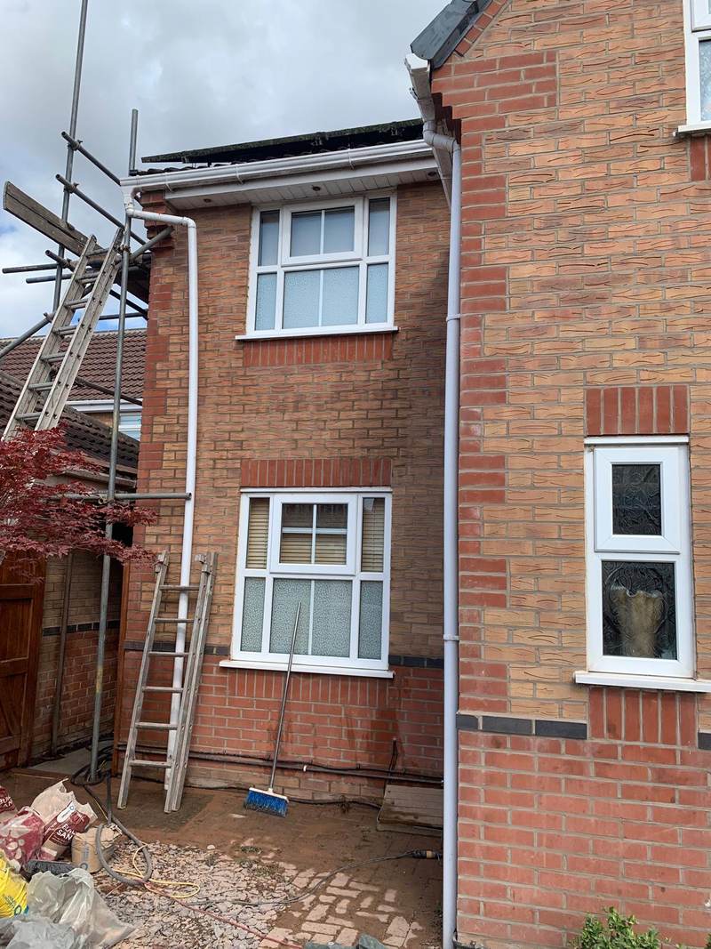Two-storey house with scaffolding during brick cleaning in Bolton