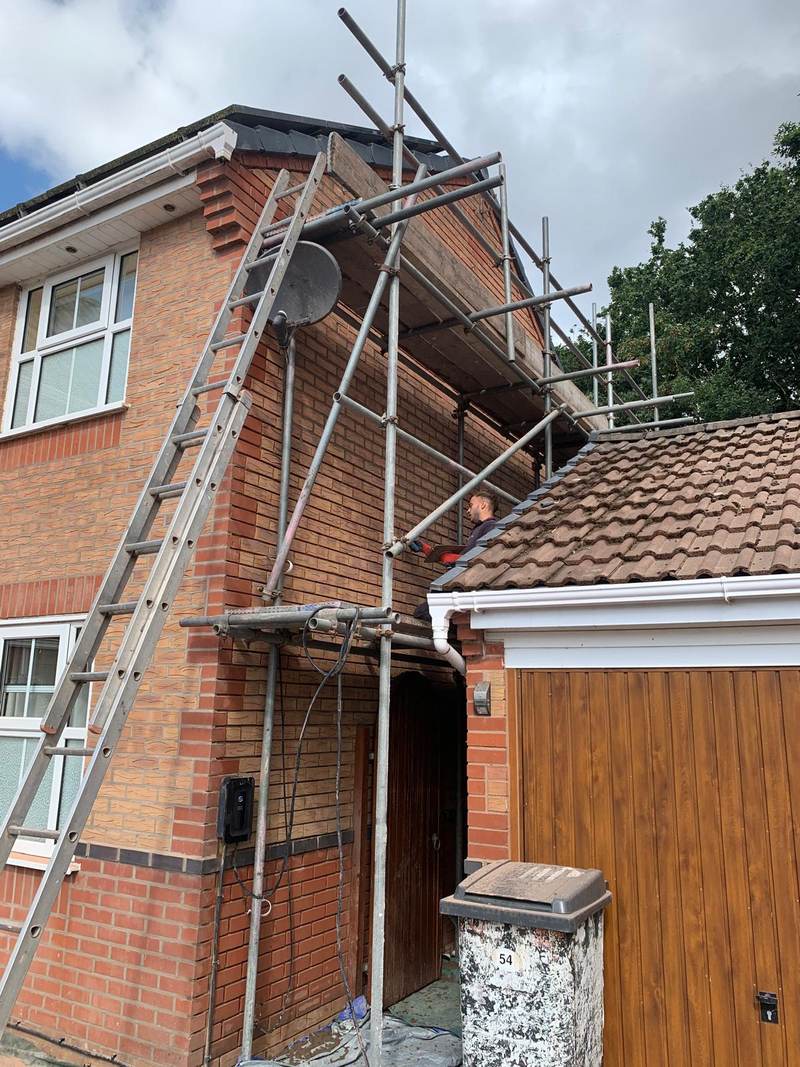 Scaffolding and ladder against brickwork during cleaning in Bolton
