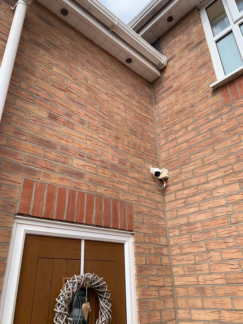 Cleaned red brickwork and soffits at the corner of a house in Bolton