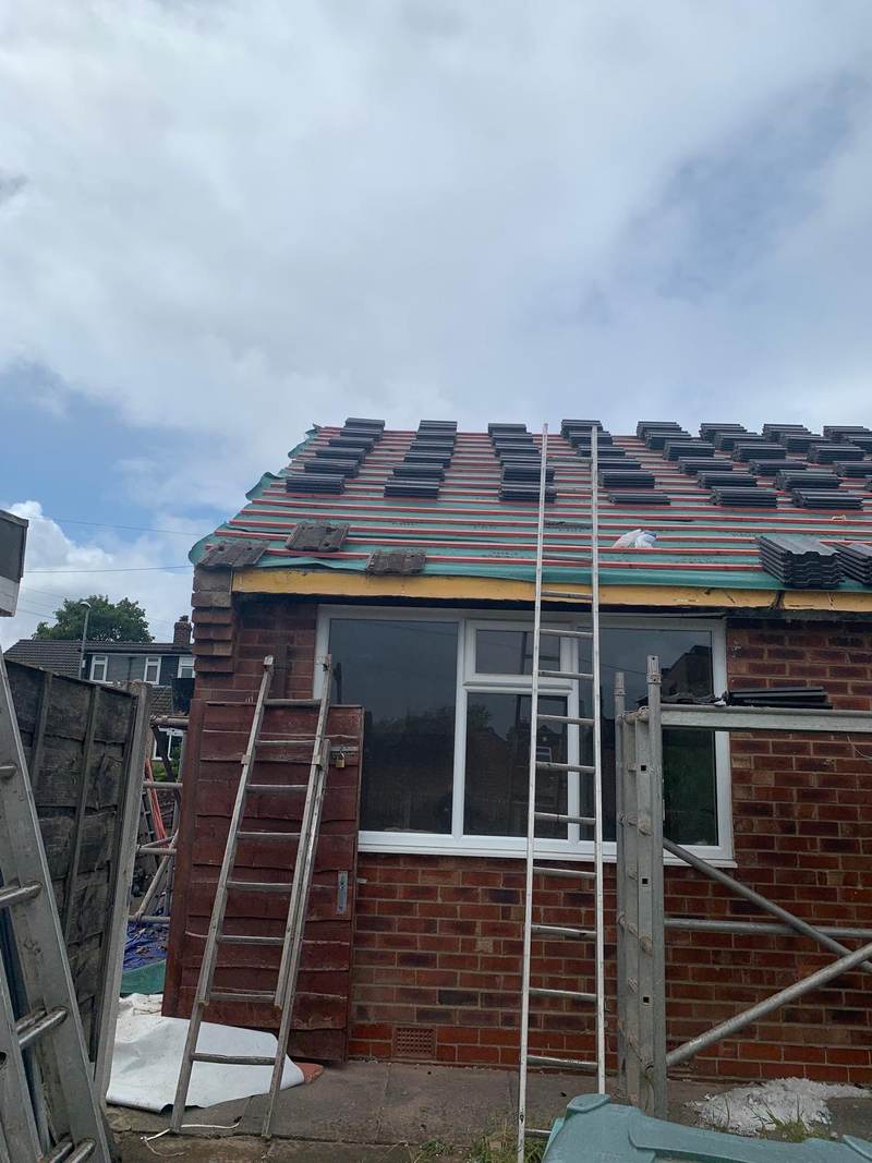 Rear roof of a bungalow being re-tiled in Bolton