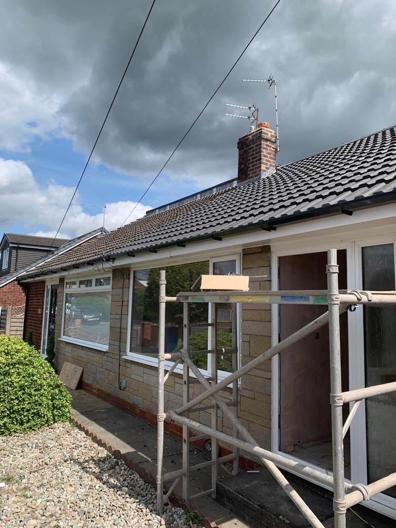 Completed bungalow re-roof with new dark concrete tiles in Bolton