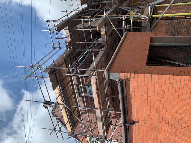 Replacing broken or missing tiles and re-pointing ridge tiles to ensure structural integrity